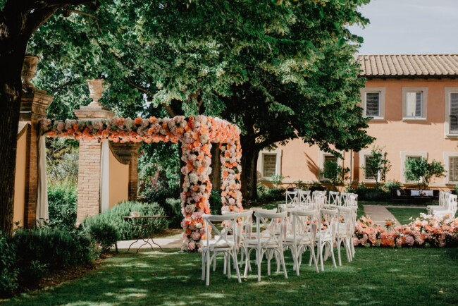 Luxury Chuppah and white wooden chairs for a Jewish ceremony