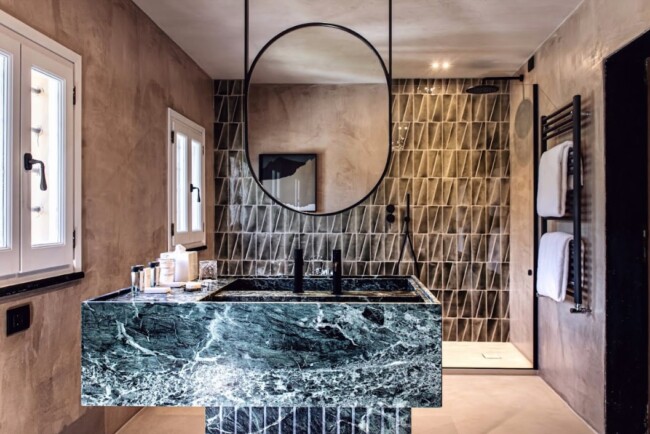 Bathroom with marble and brown tiles of villa in the Italian Riviera
