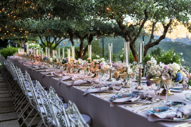 Elegant garden table set up under olive trees