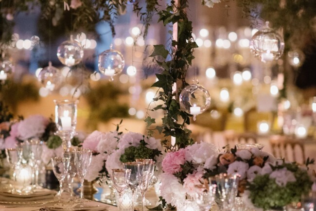 Hanging greenery and candels and elegant table setting for a wedding in Rome