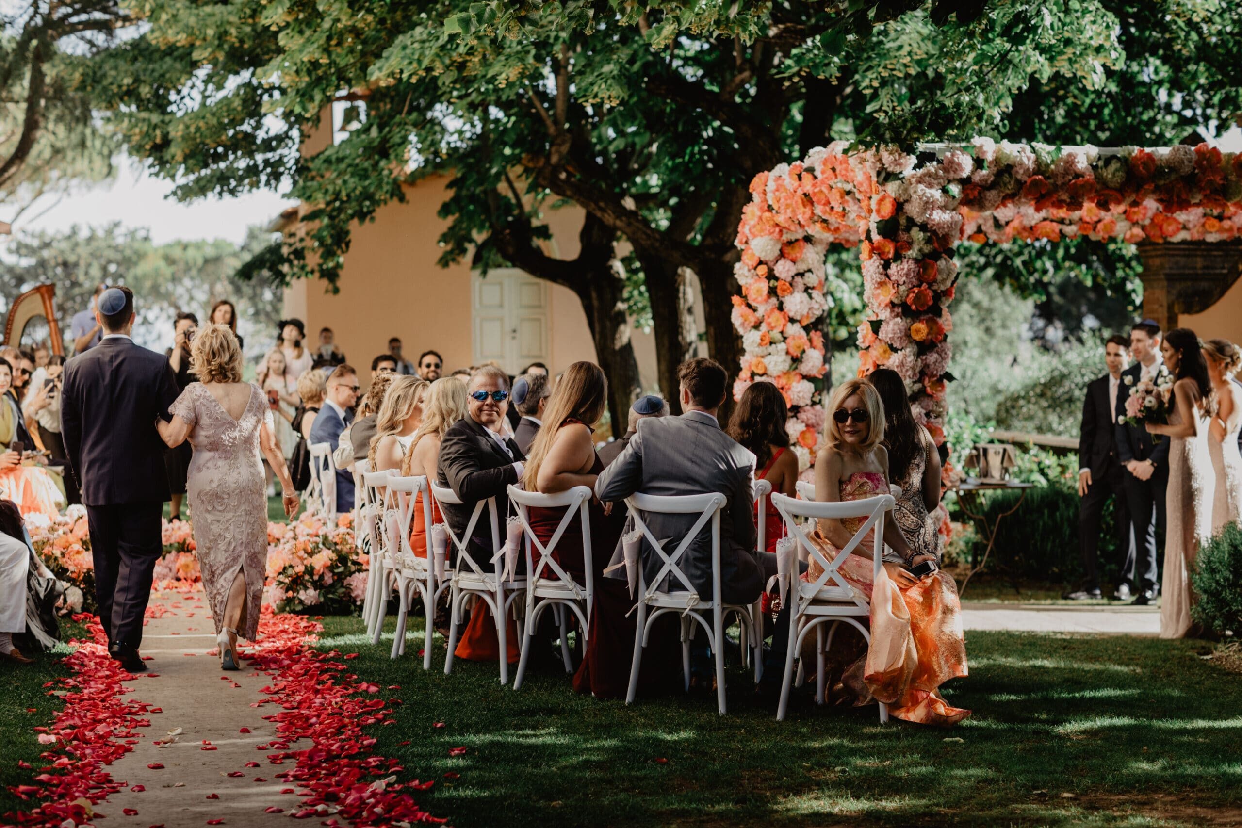 Chuppah with coral, pink and ivory flowers
