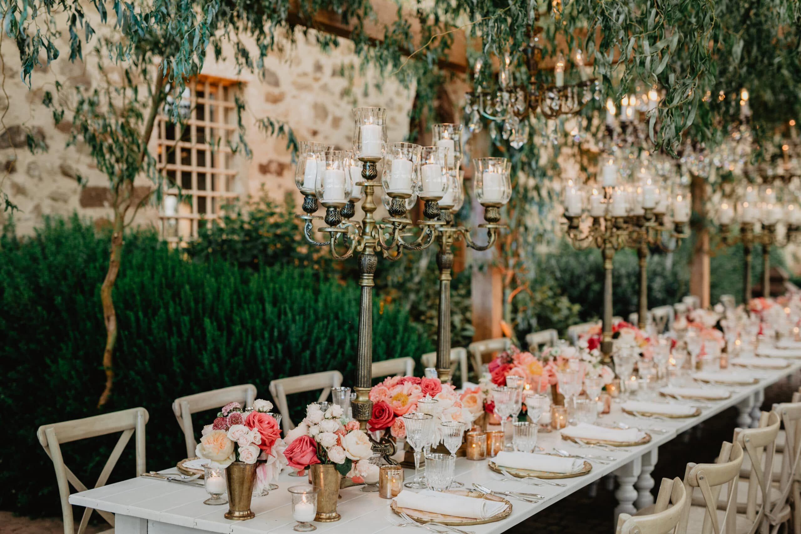 White wooden table and bronze candelabras as wedding decor