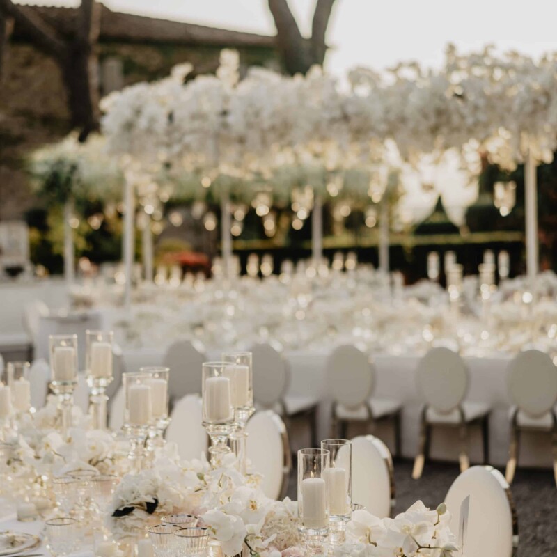 Tables at the sunset with cascading orchids