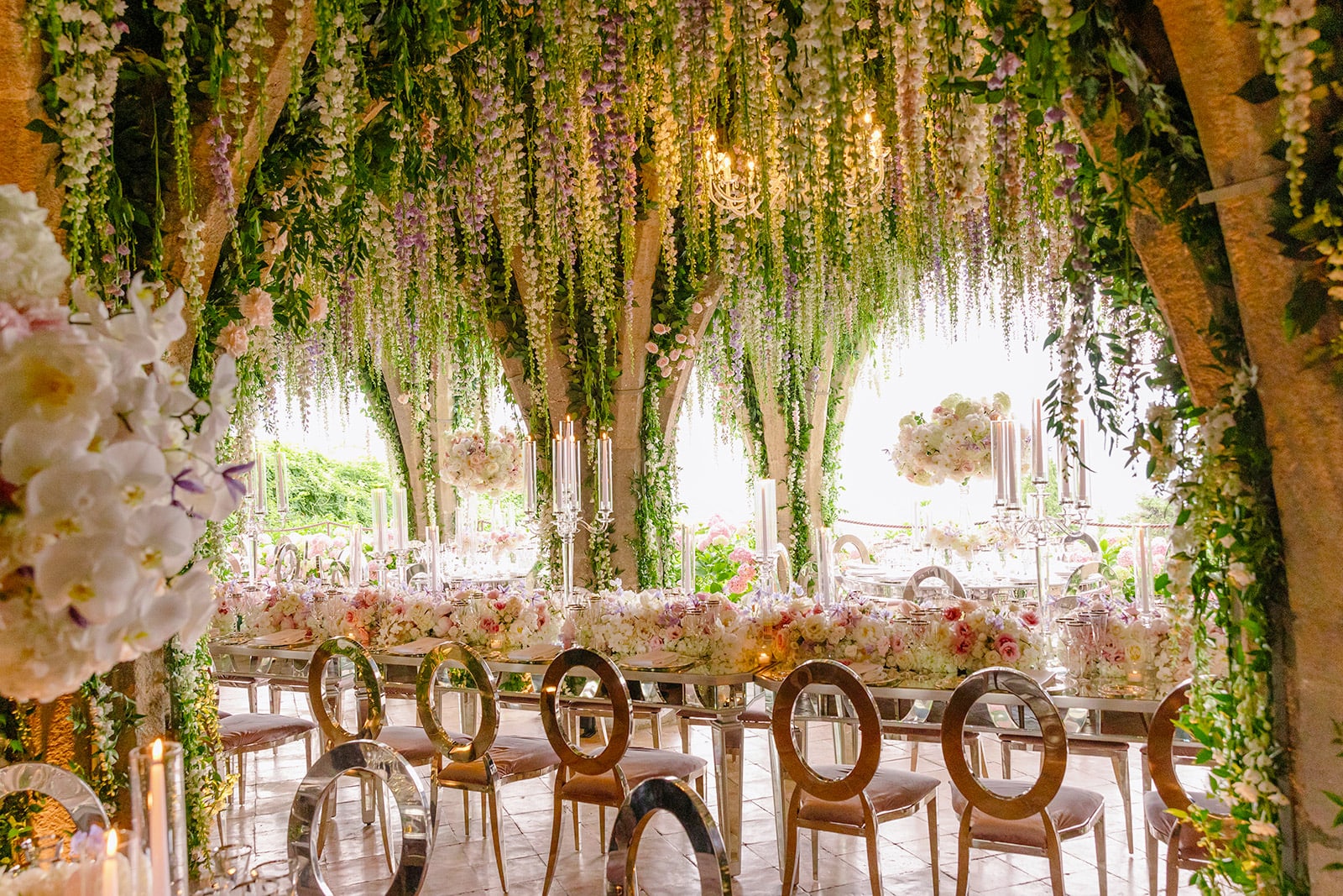 Long table with white and pink flowers for the wedding dinner in the crypt