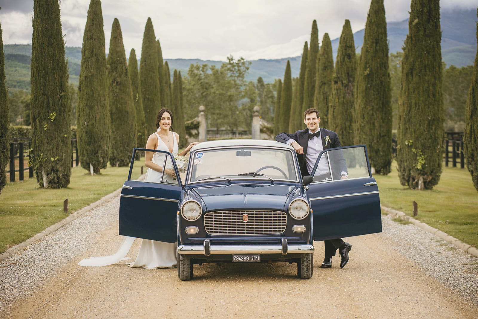 Couple and vintage car at the Italian vineyard wedding venues