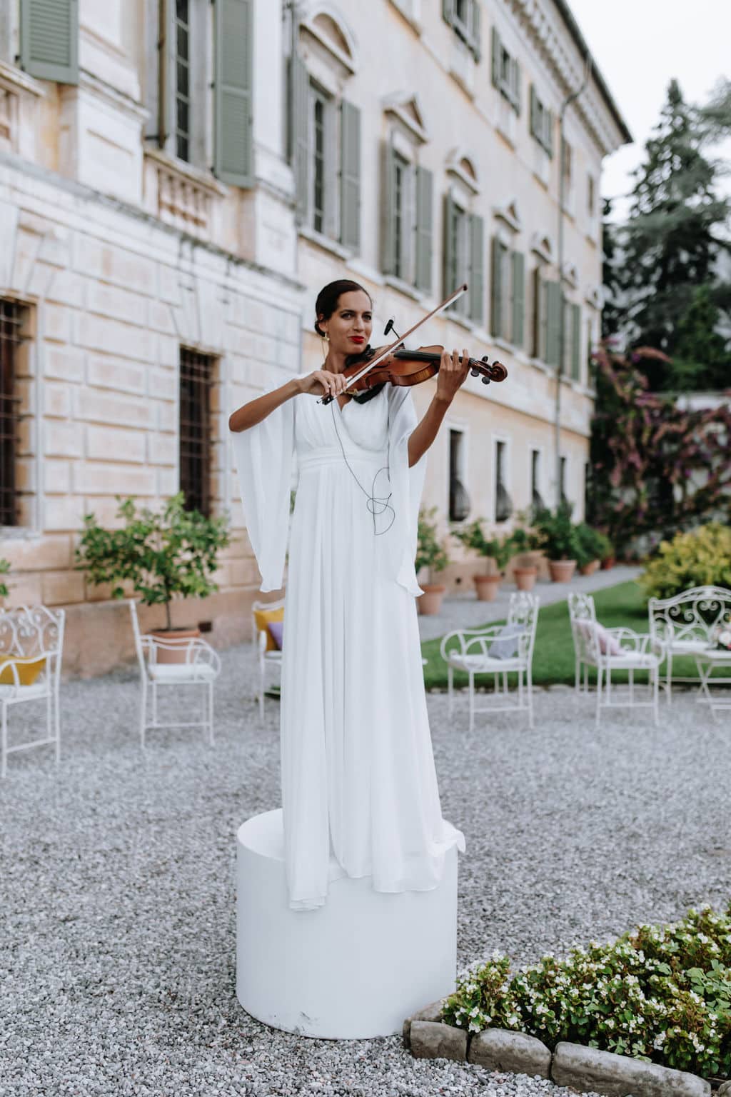 Violinist woman with elegant white dress