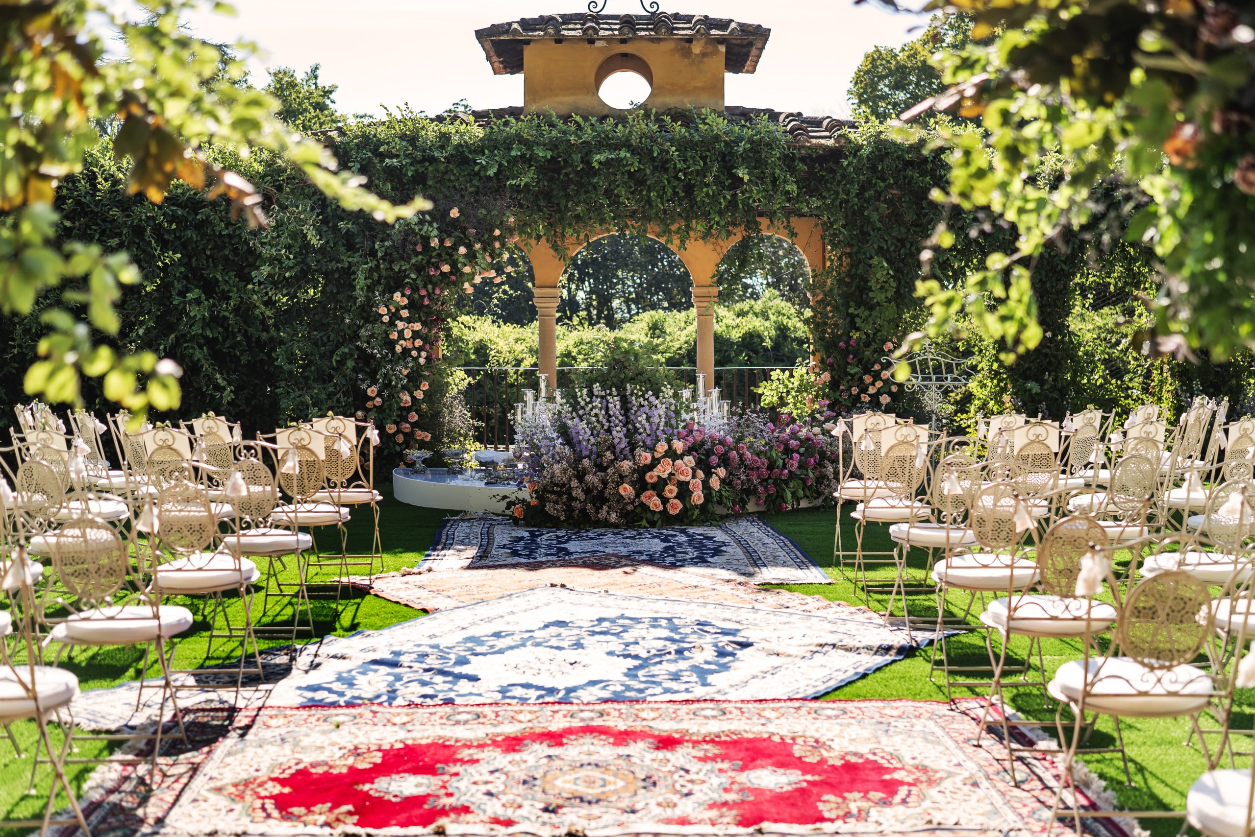 openair persian ceremony with carpets, white chairs